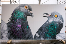 Adele Renault malt eine Wand auf dem Lollapalooza Festival, die eine realistische Darstellung von Tieren und lebhaften Farben zeigt.